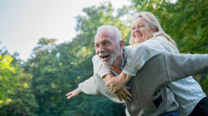 Happy senior couple smiling outdoors in nature